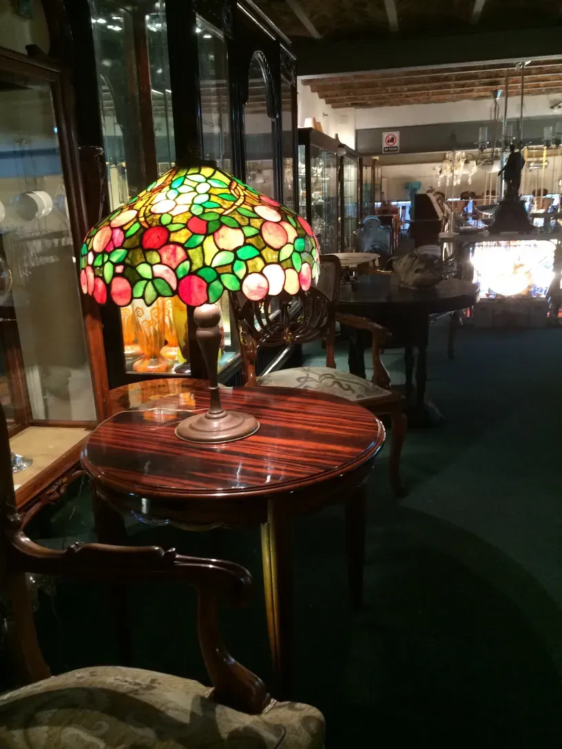 Antique small table with colorful design and decorative lamp