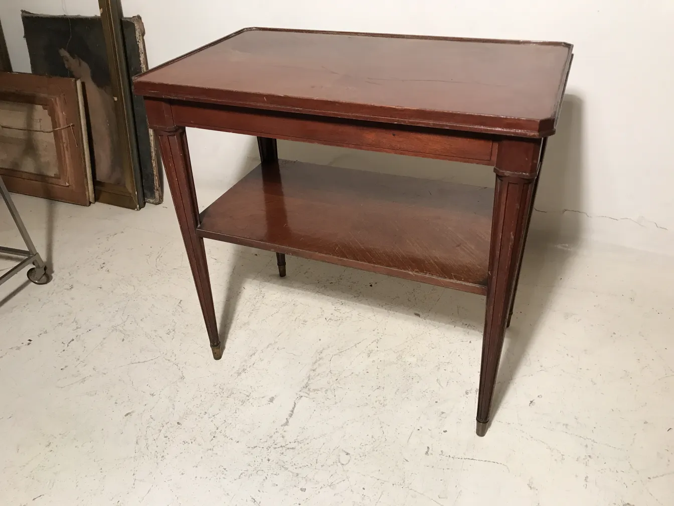 Antique small table from Nordiska Kompaniet with lower shelf in an antique setting.