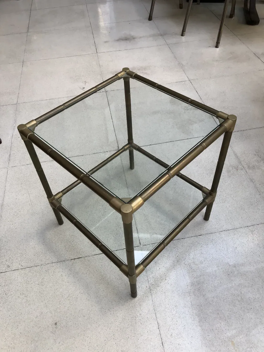 antique small table with metal frame and glass top in minimalist setting