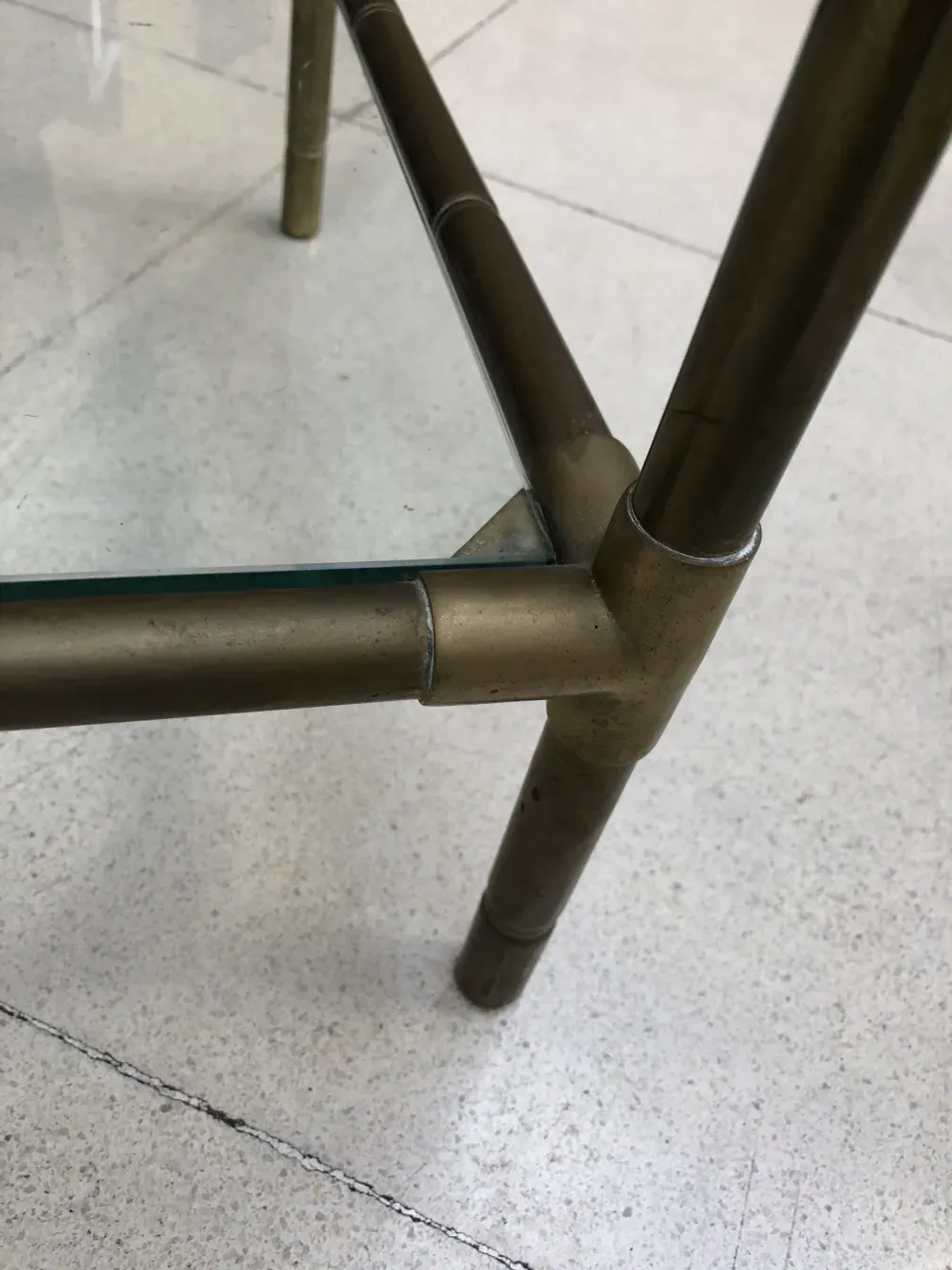 antique small table with simple shape and tubular legs, neutral environment