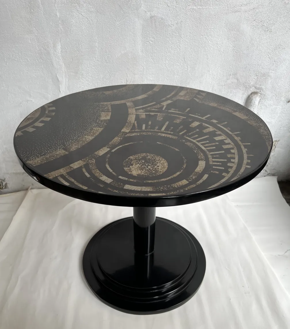 Antique small table with geometric design in a bright setting.