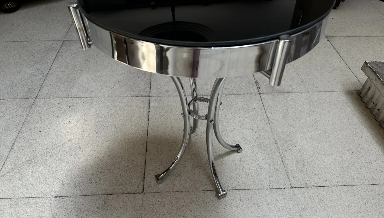 Antique round table with curved base and black top