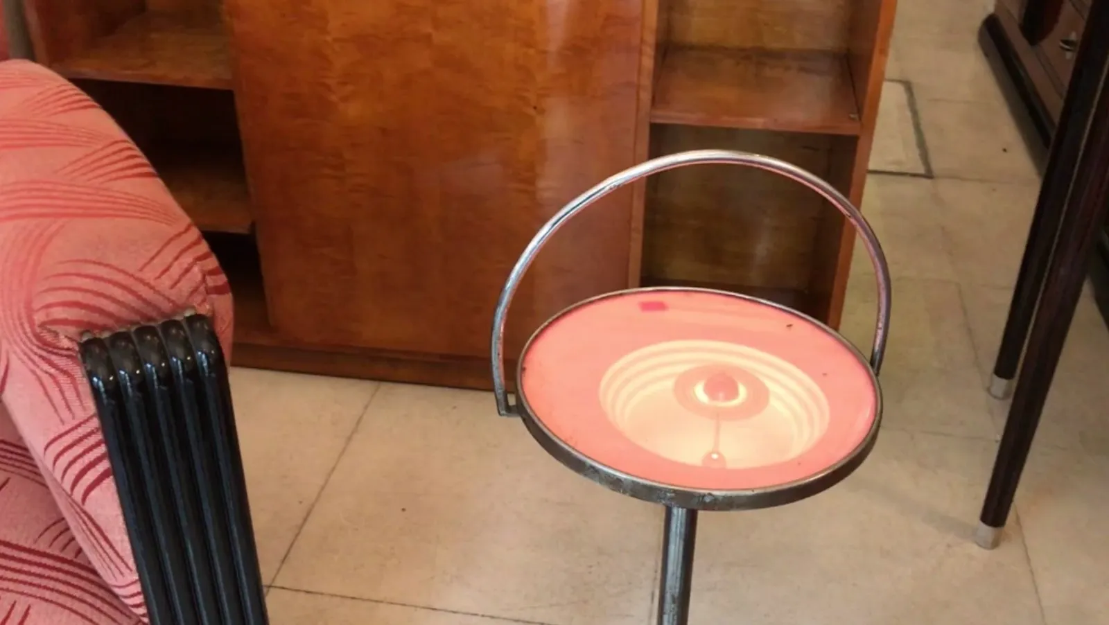 Antique small table with decorative design, in a retro setting