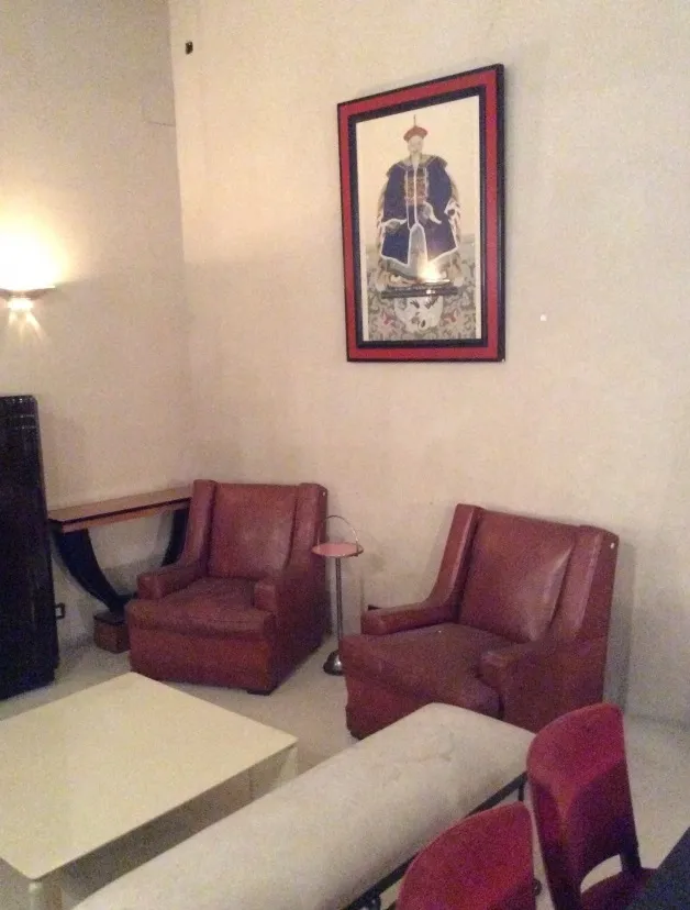 petite table ancienne dans un cadre confortable avec fauteuils et art