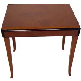 Antique small table with a smooth surface and elegant legs in a cozy setting.