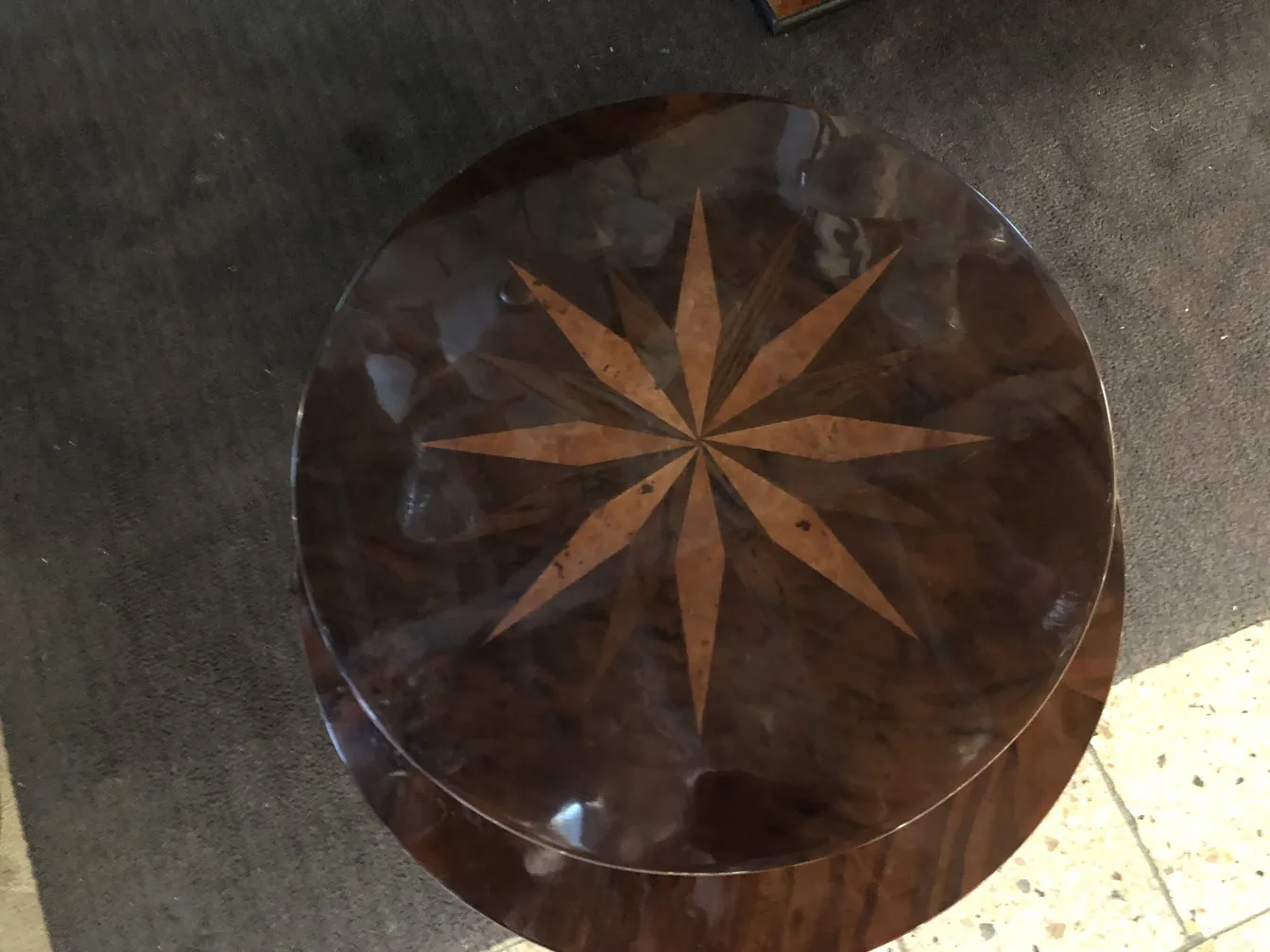 antique small table featuring star design on top, cozy setting.