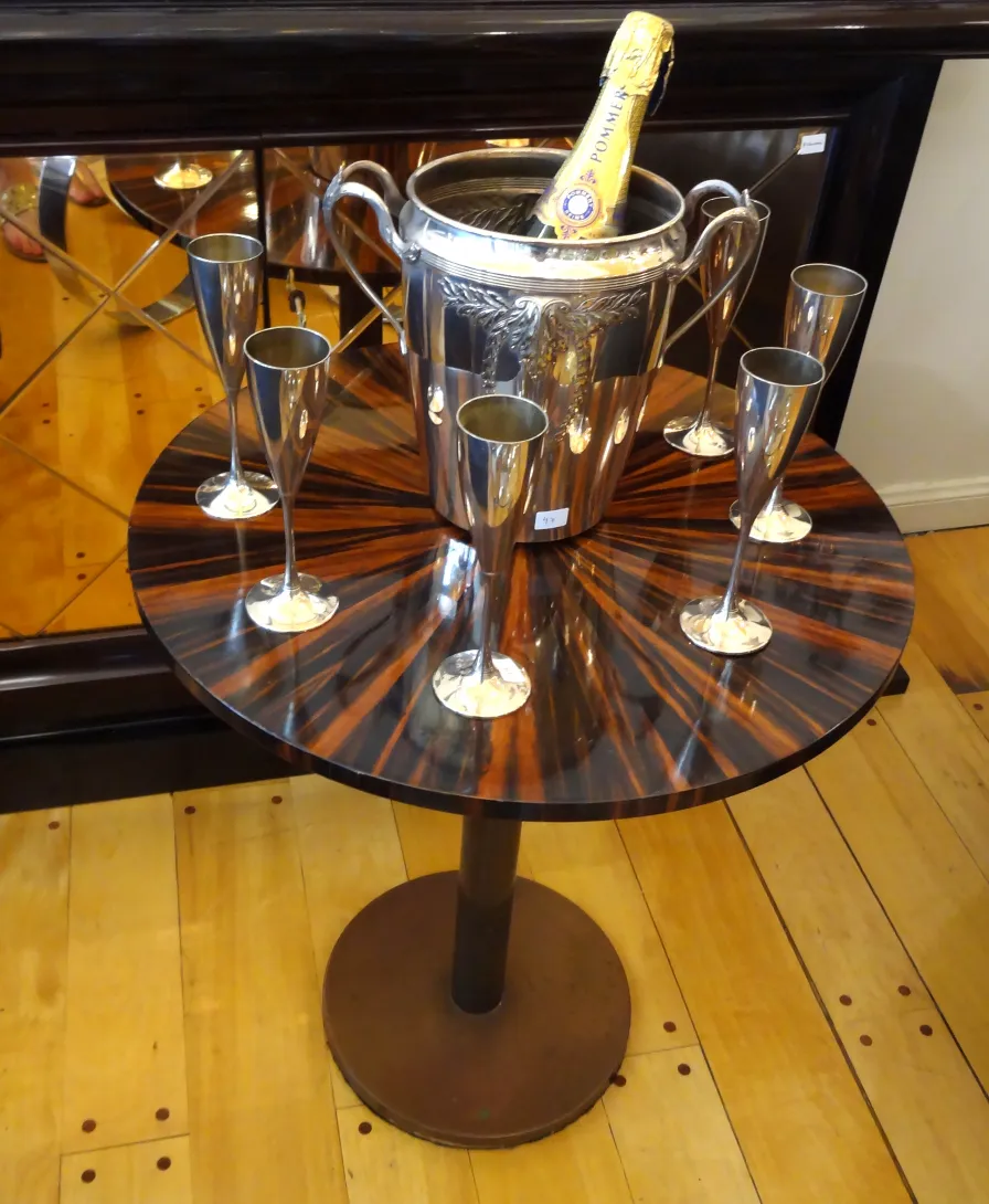antique small round table with decoration and glasses