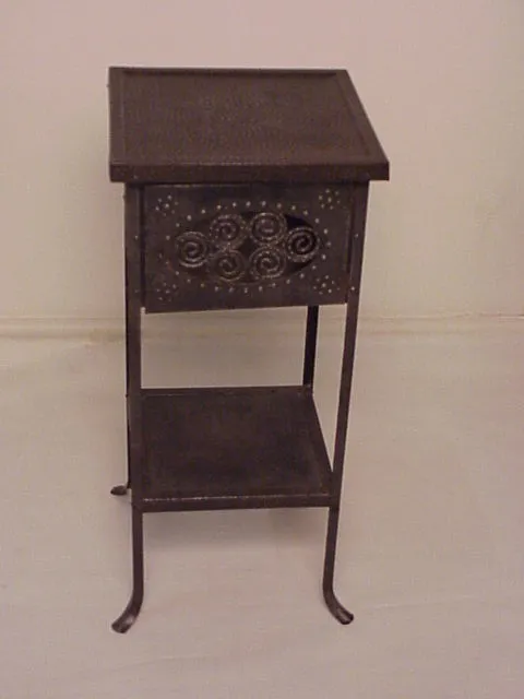 antique small table featuring a decorative front design