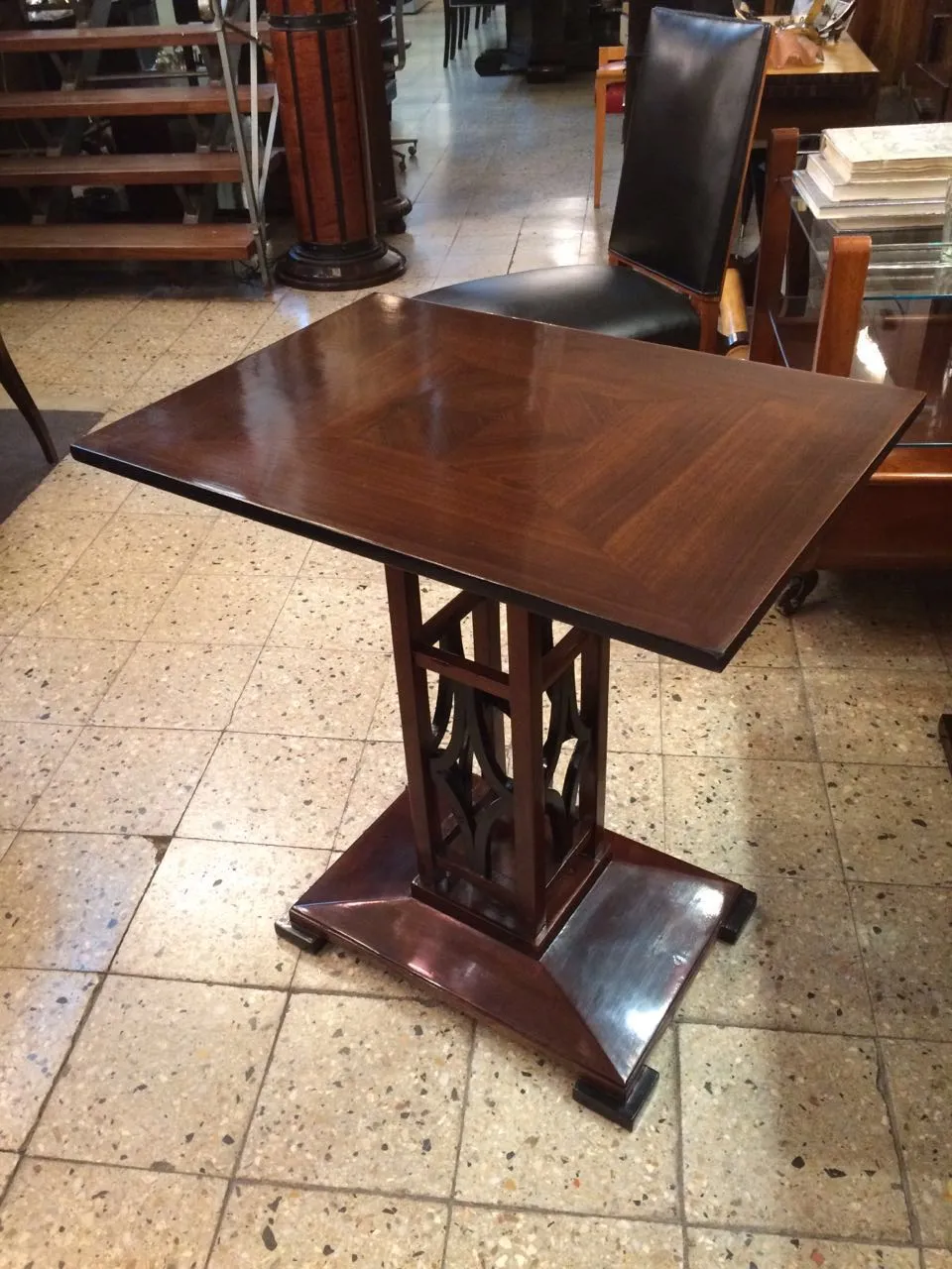 an antique small table with a decorative design in an elegant setting