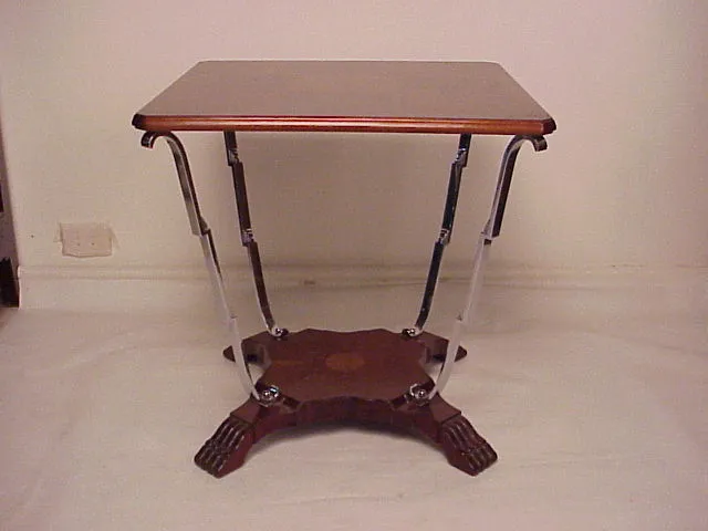 Antique small table with decorative legs and classic style.