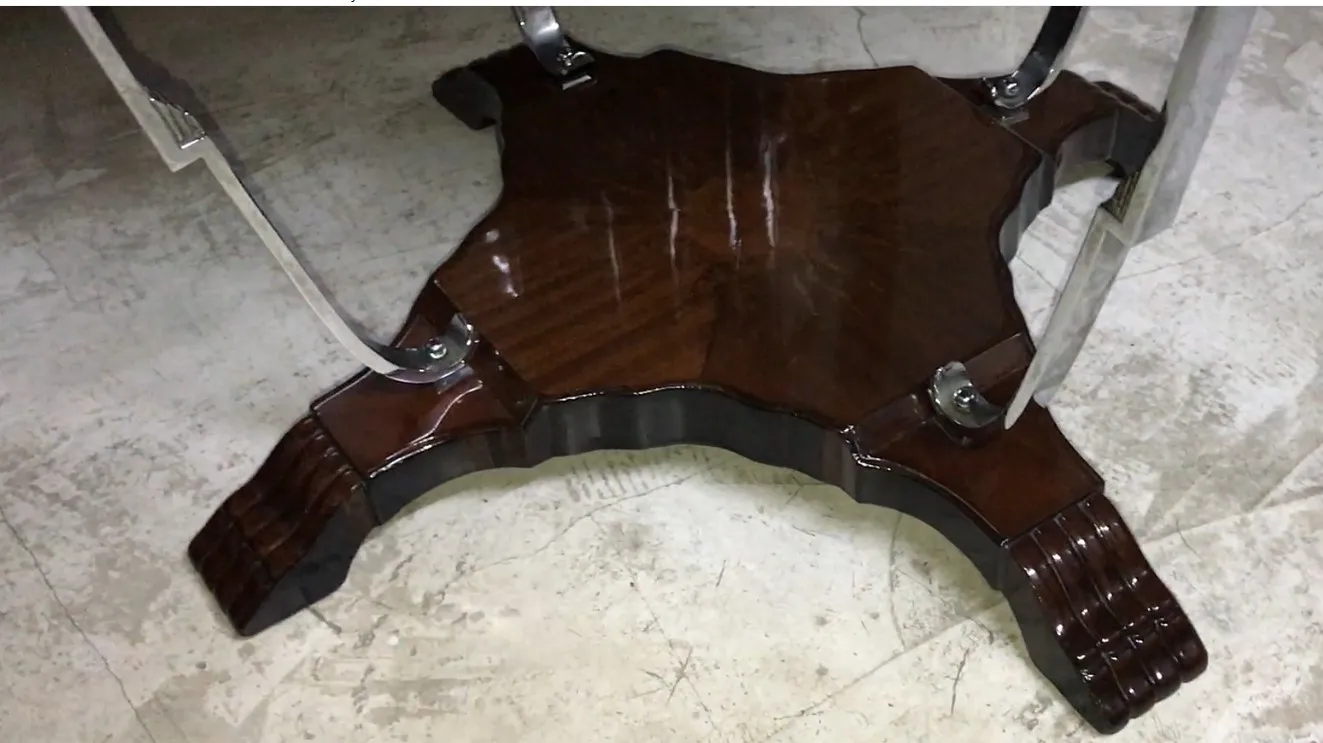 Petite table antique avec un design distinctif et des pieds décoratifs dans un cadre élégant.