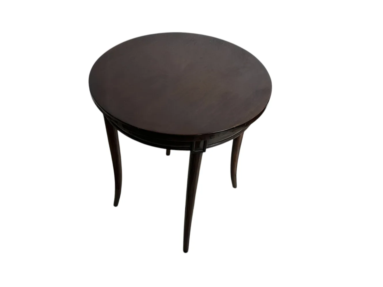 Petite table ancienne ronde avec des pieds allongés.