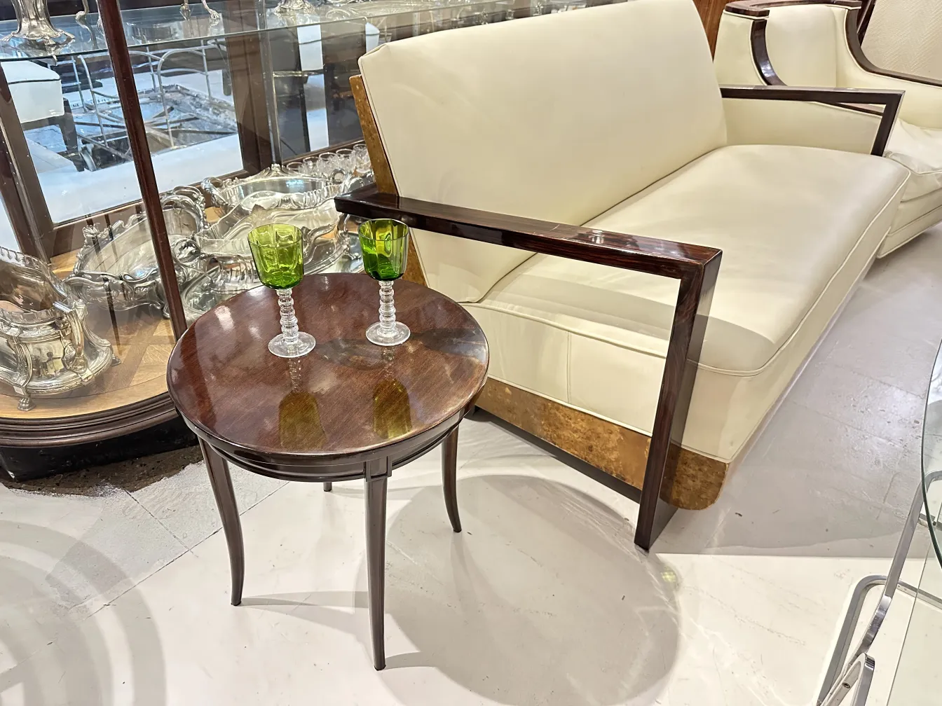 petite table ancienne en bois avec deux verres verts au-dessus