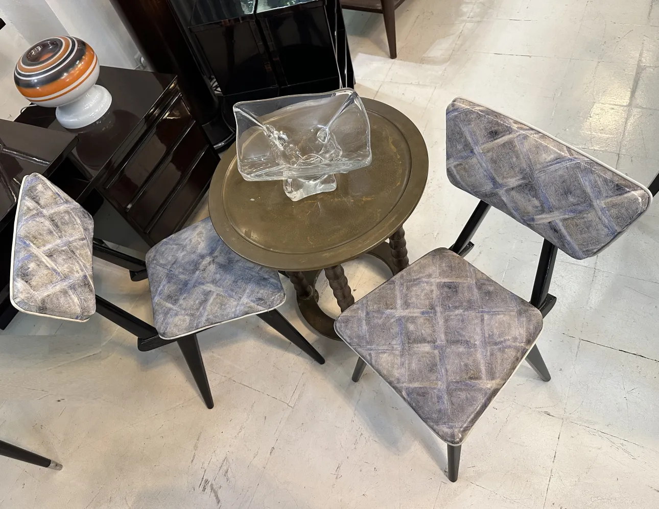 Antique small table with a decorative design, adorned in a classic setting.