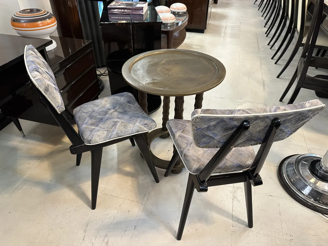 antique small table with classic design and chairs in background