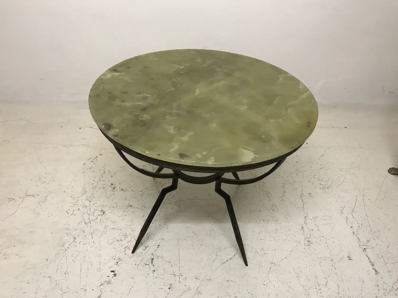 small round antique table with a decorative elegant design in a minimalist setting