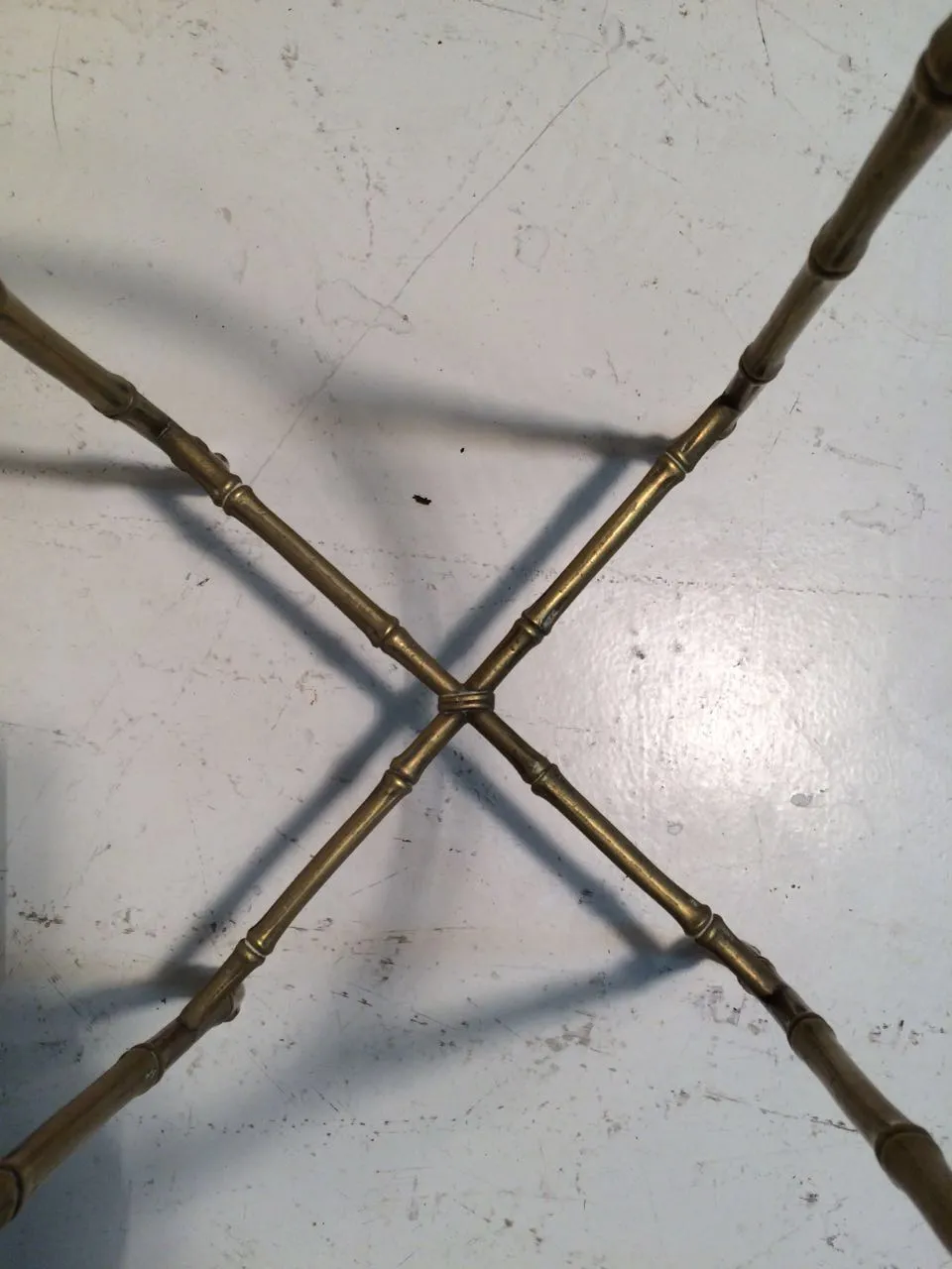 bottom view of an antique small table by Maison Bagues with gold legs.