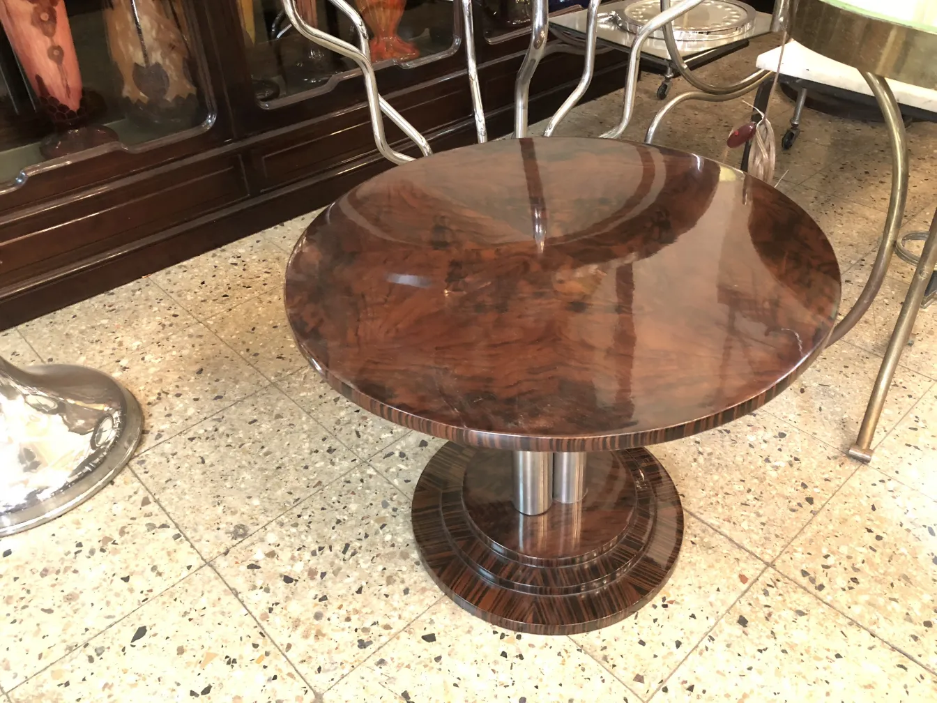 Two vintage small tables with round shape and glossy finish, classic setting.
