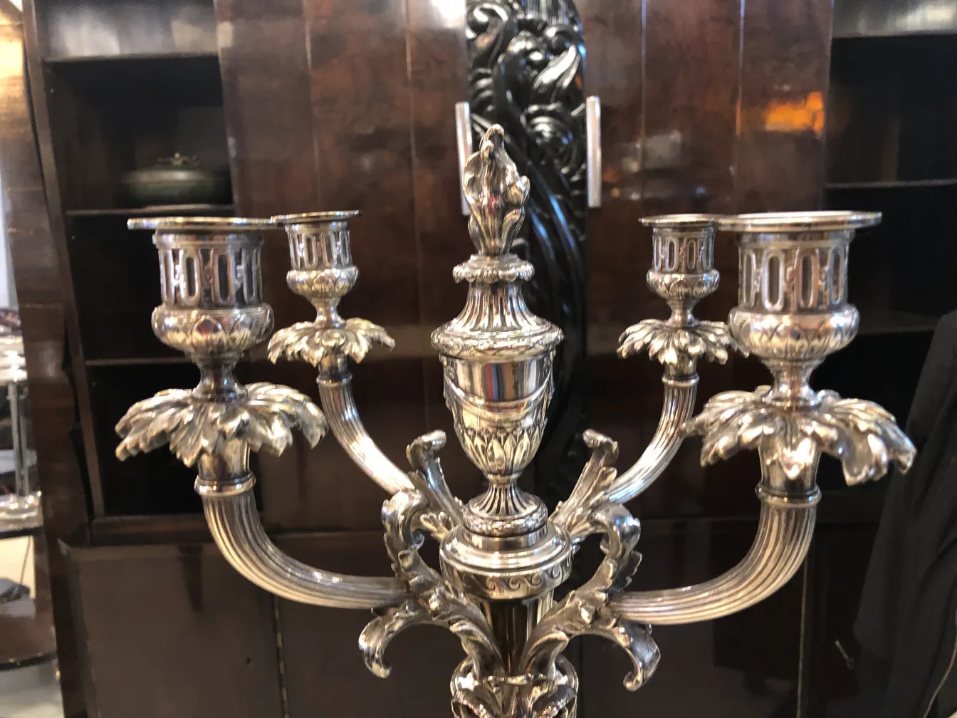 Antique candelabras with intricate and elegant design, near a dark background