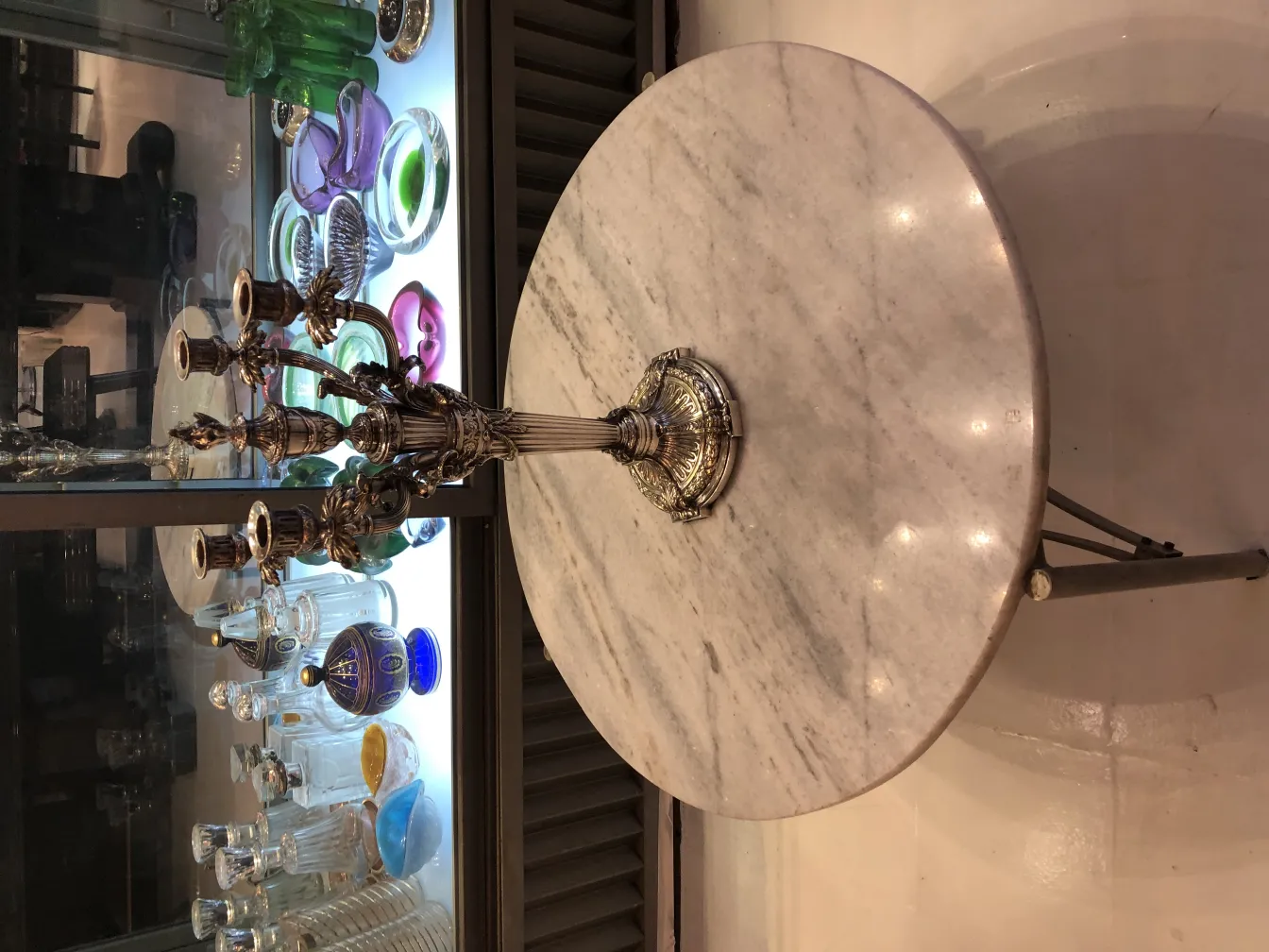 Due candelabri antichi in stile Art Nouveau, circondati da oggetti decorativi in un ambiente elegante.