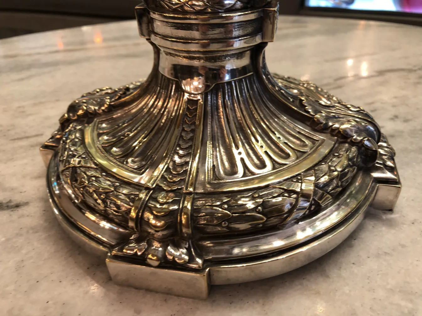 two antique candelabras with ornamental details