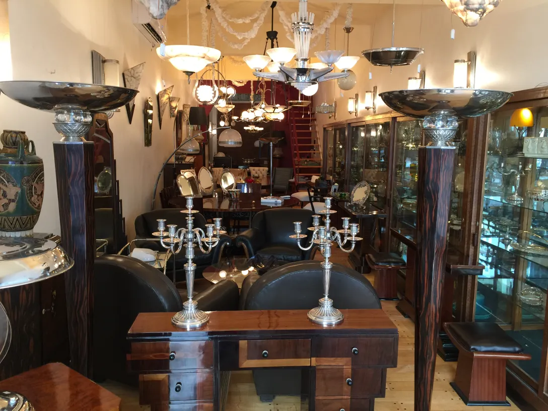 two antique decorative candelabras in a display room with Art Nouveau style