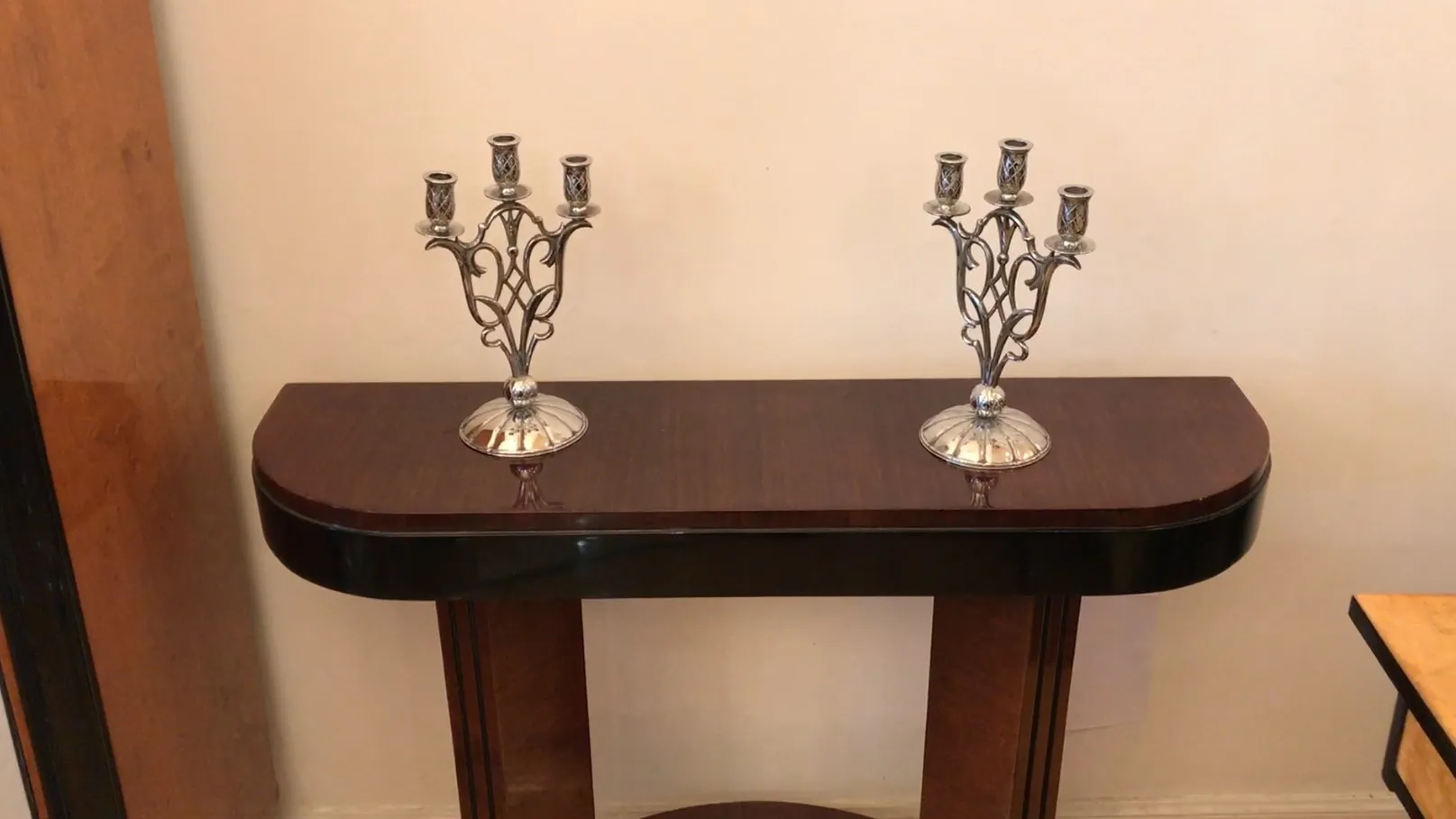 Two antique candlesticks on a stylish table.