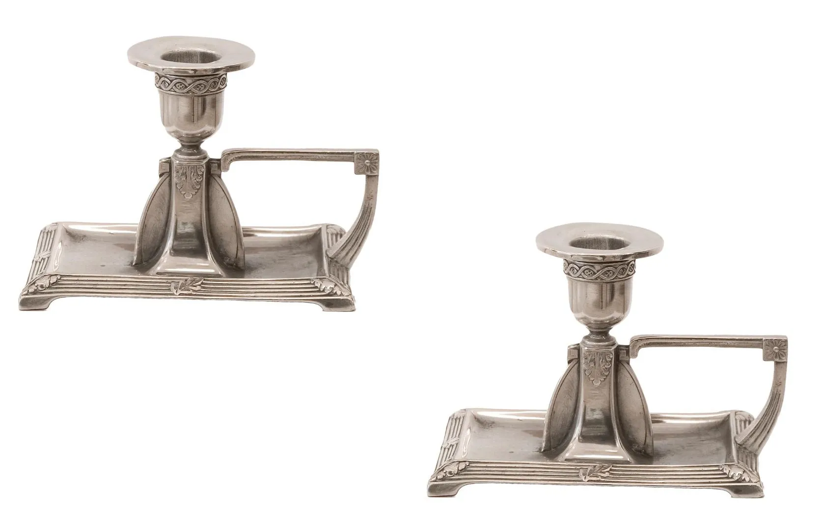 pair of antique candlesticks with detailed shape and decorative base, white background