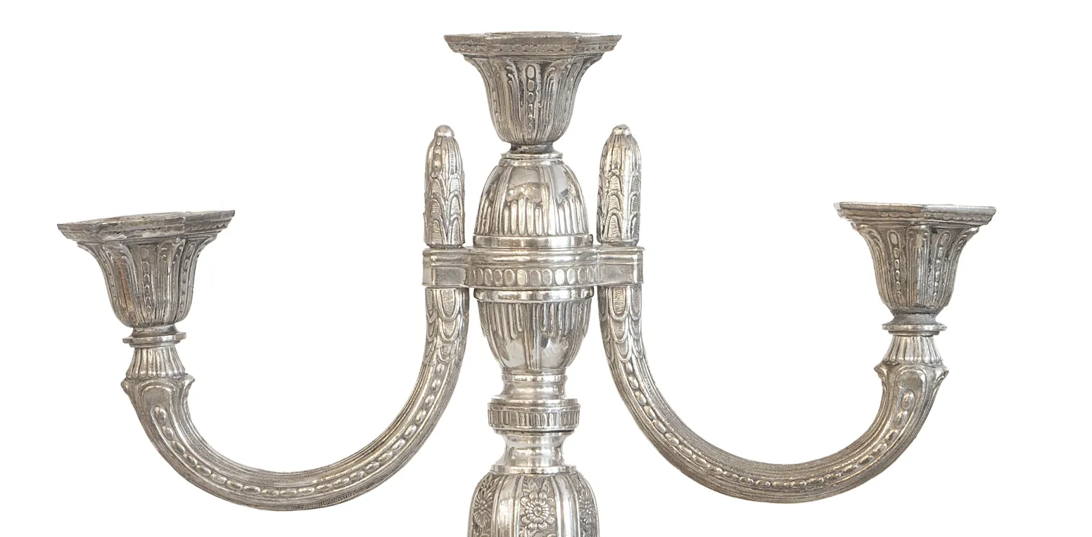 Two antique art nouveau candelabras with elegant shapes and decorative details