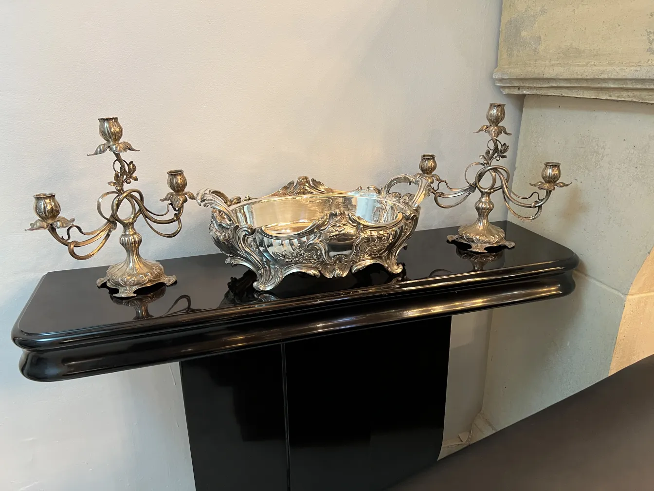 Two antique candelabras in Art Nouveau style with decorative arms.