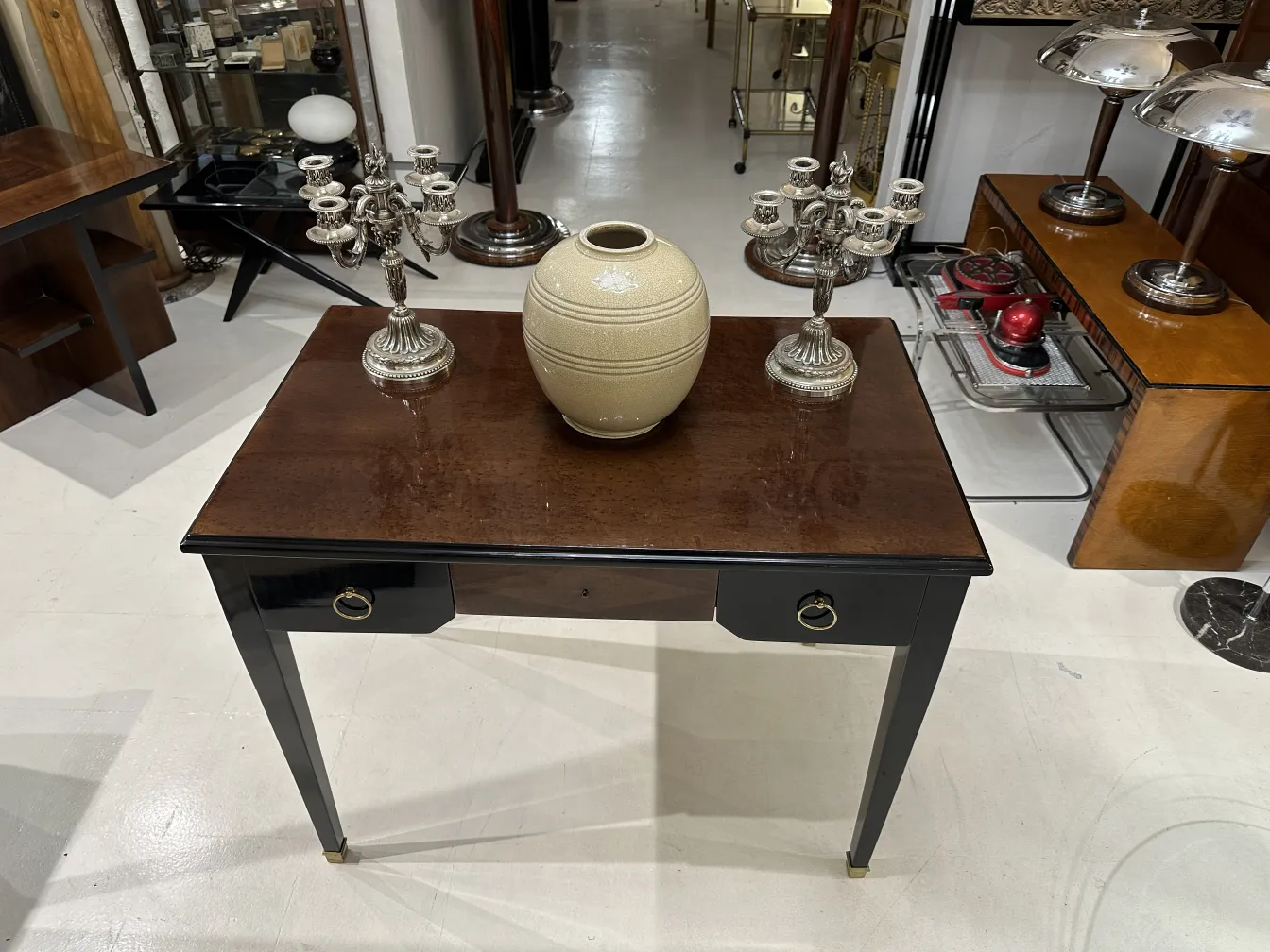 two antique candelabras adorning a wooden table