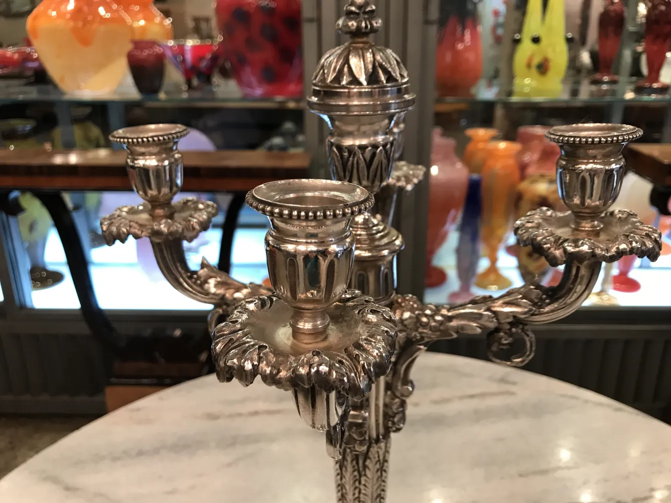 two antique candelabras with ornamental details
