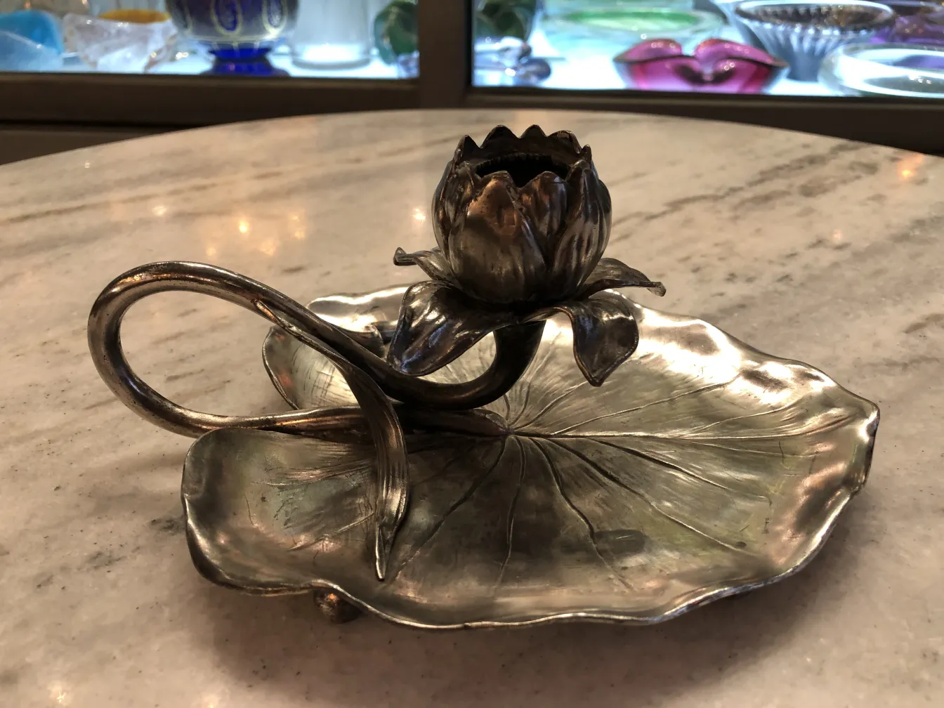 Antique candelabra with floral design on base in Hindi