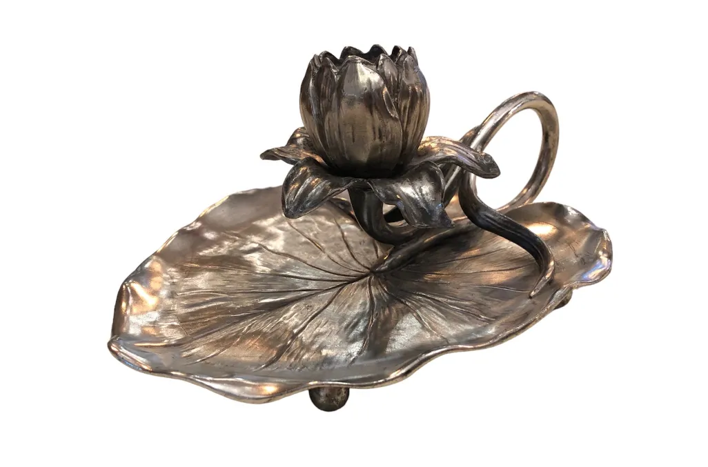 Antique art nouveau candelabra shaped like a flower at the base.