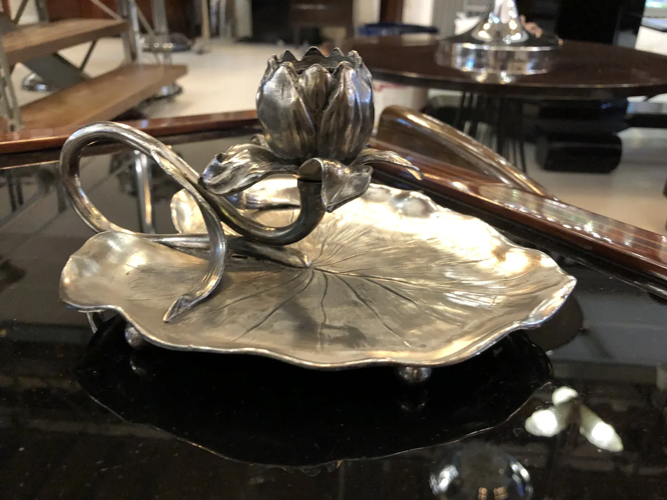 Antique candelabra with a leaf shape and lotus flower atop