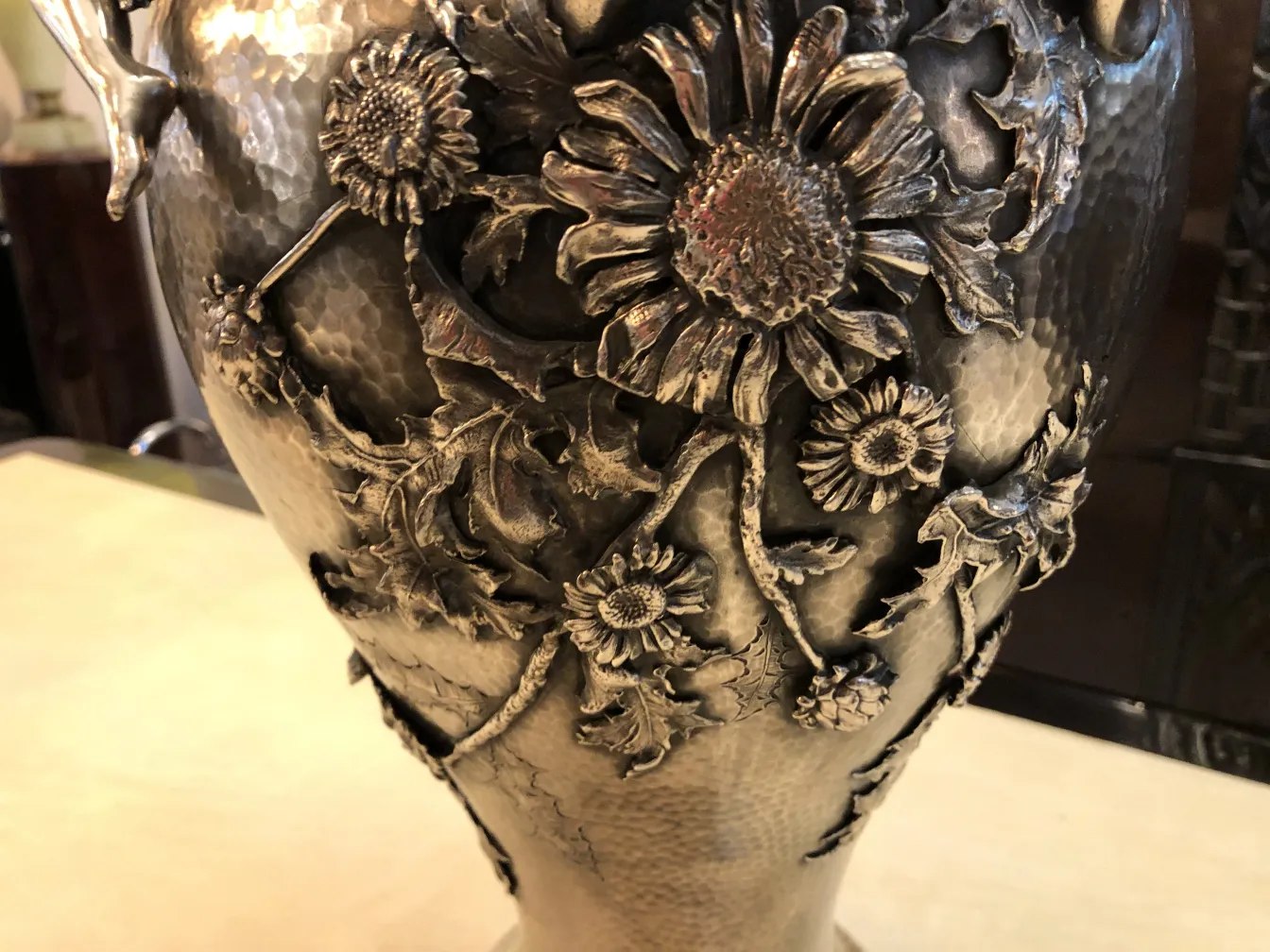 two antique vases adorned with floral relief and leaves