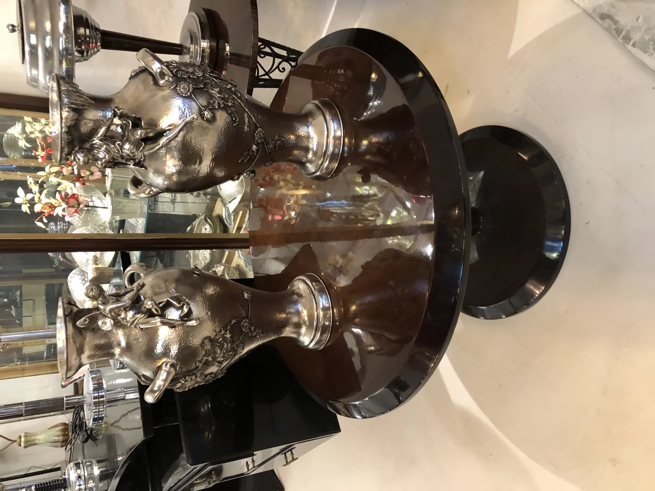 two antique vases with art nouveau design on a table