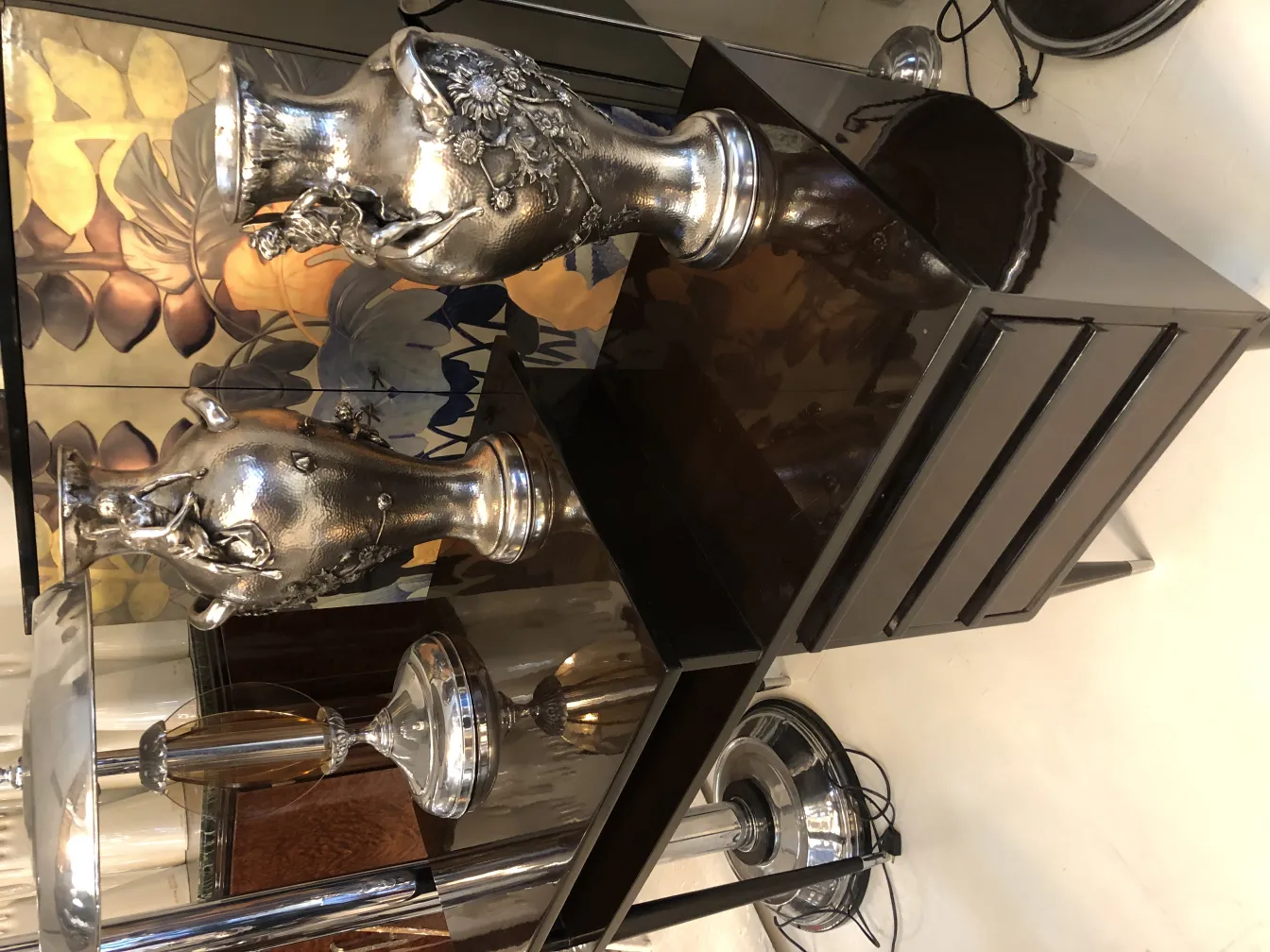 Two antique vases in Art Nouveau style with decorative details in an elegant setting.