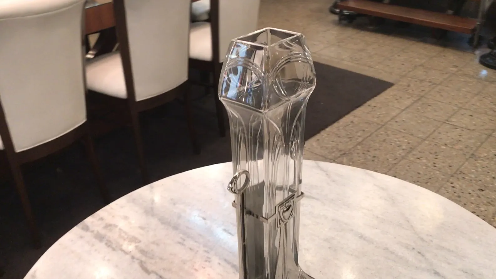 Dois vasos antigos em estilo Art Nouveau, elegantemente decorados em um ambiente de jantar.