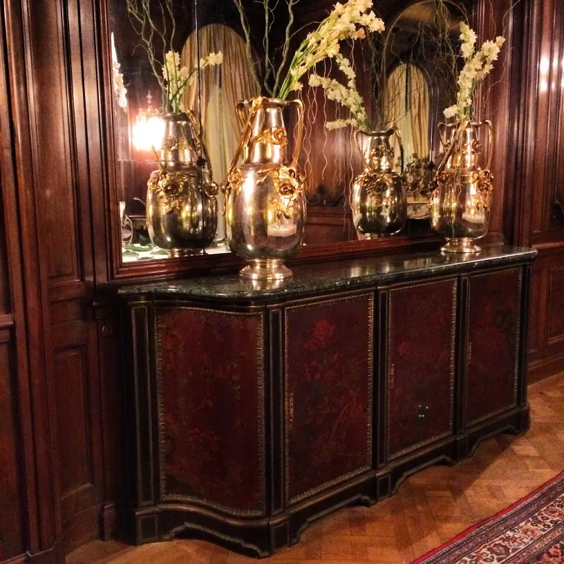 दो प्राचीन फूलदान फूलों के साथ एक क्लासिक सेटिंग में।