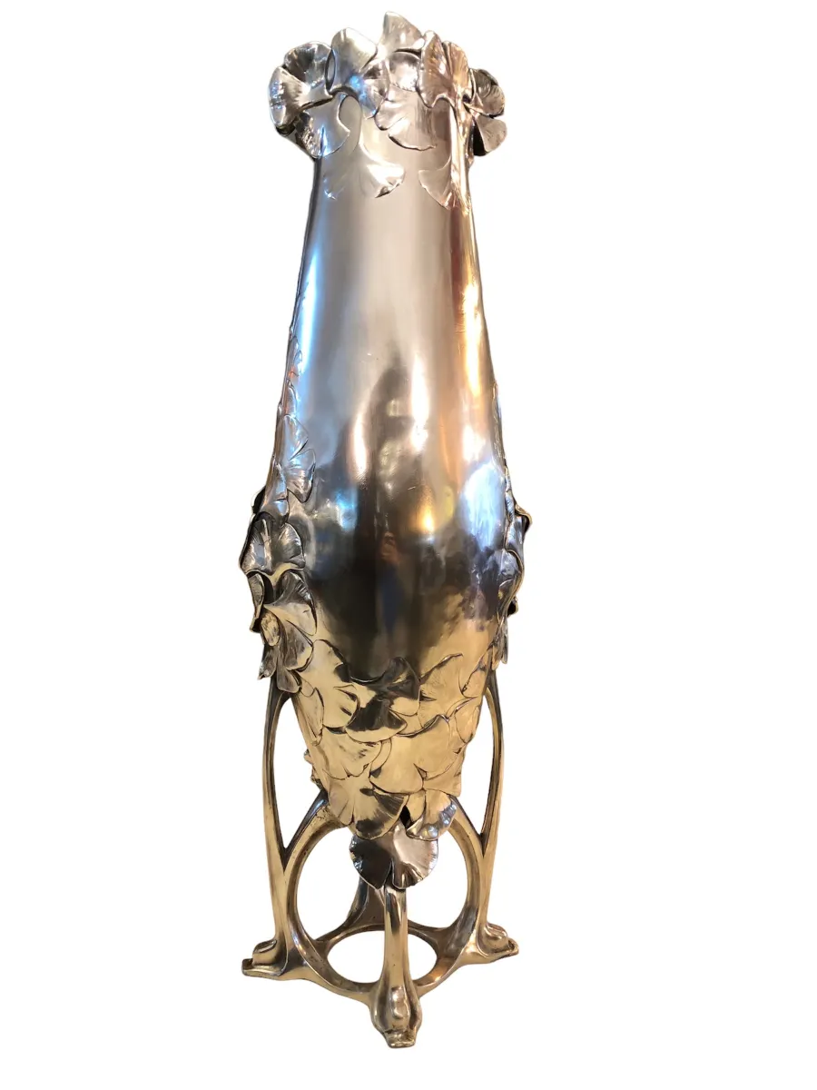 antique vase with elegant shape and floral Art Nouveau details, against a neutral background