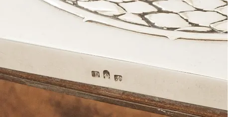 Espejo antiguo con detalles decorativos en el borde.