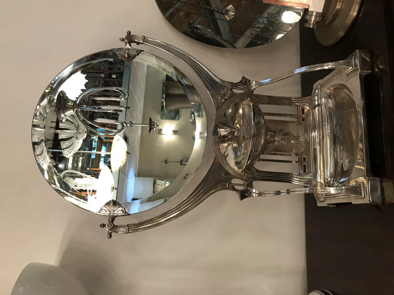 antique mirror with decorative base and circular shape