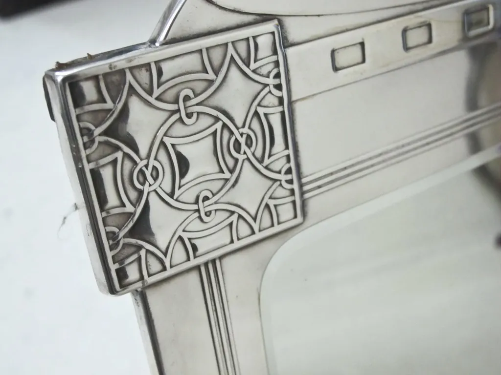 antique mirror featuring intricate border details