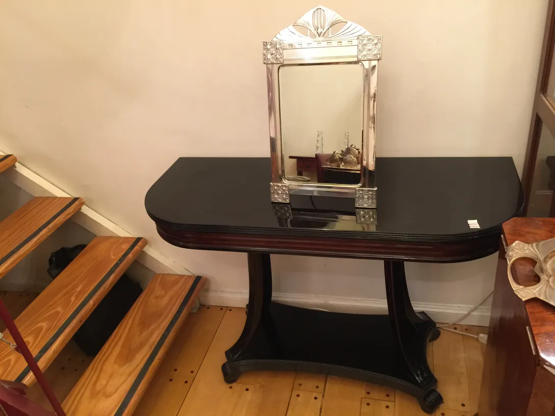 Espelho antigo com moldura ornamentada em ambiente elegante.