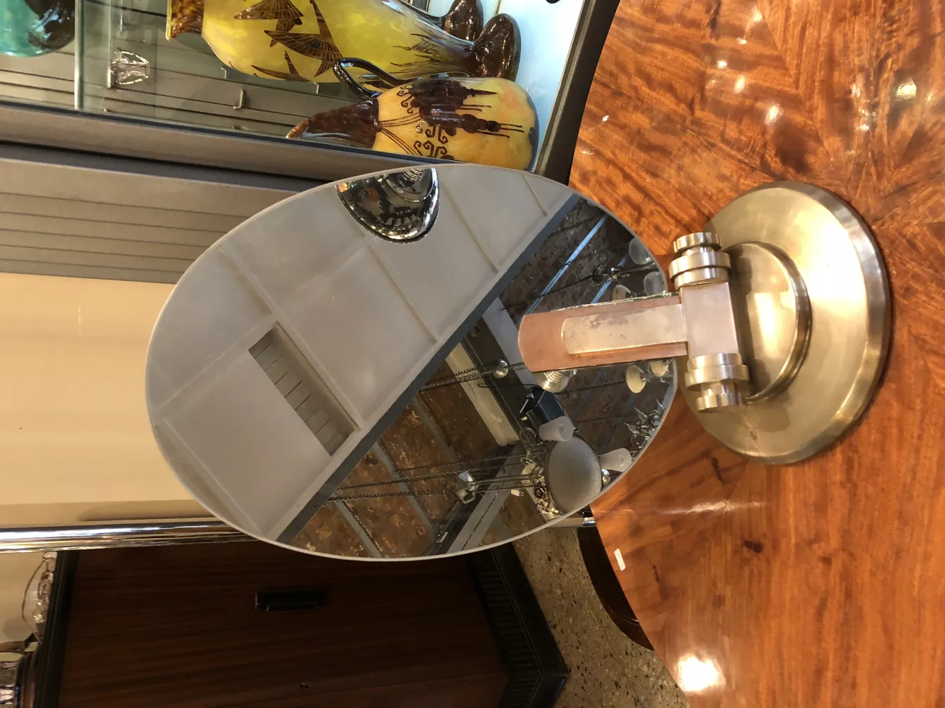 antique oval mirror with circular base