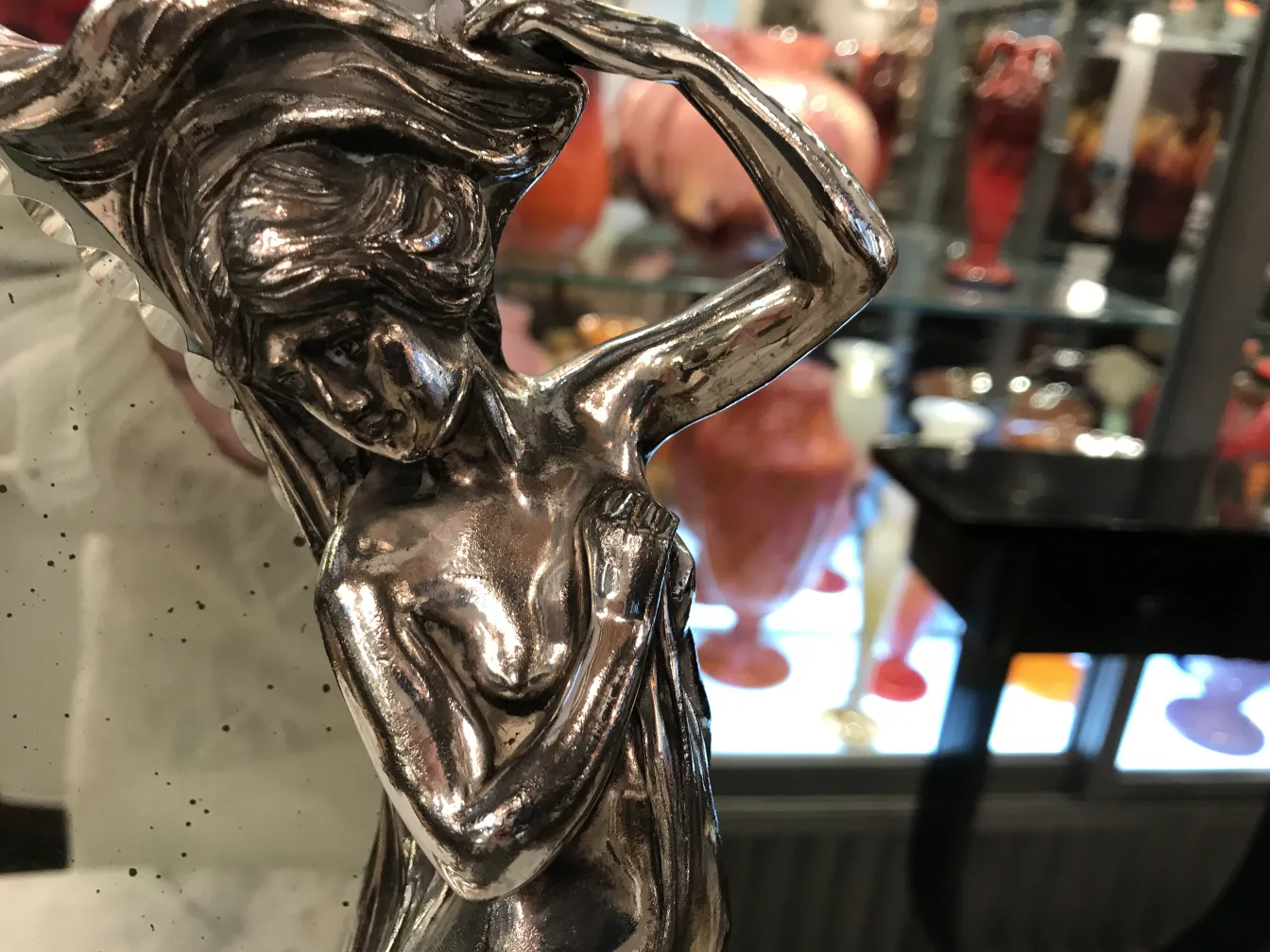 아르누보 디자인의 고전적인 거울, 배경에는 다채로운 꽃병.