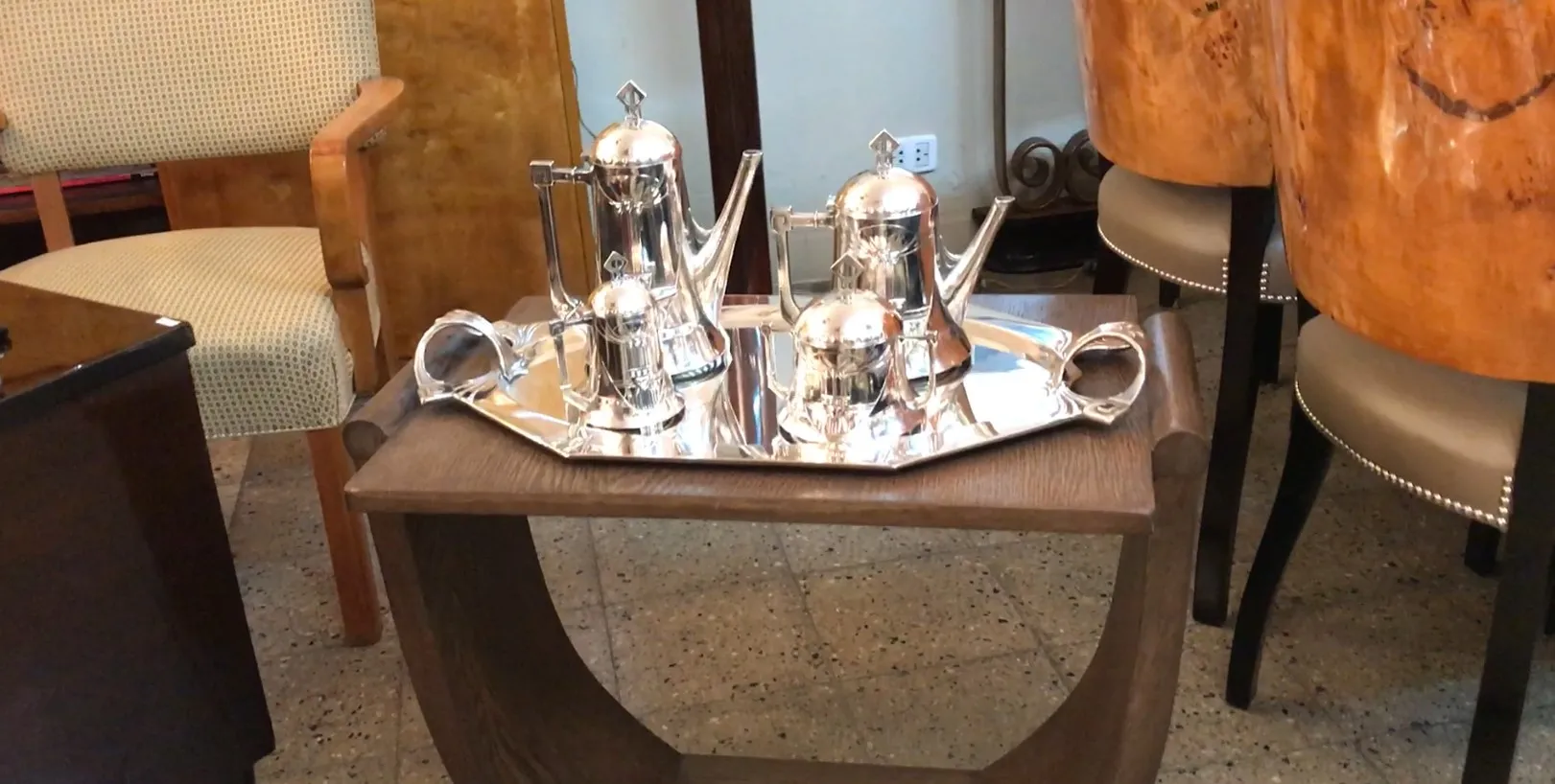 antique WMF tea set with shiny and elegant decor on a tray, accompanied by cup and jug.