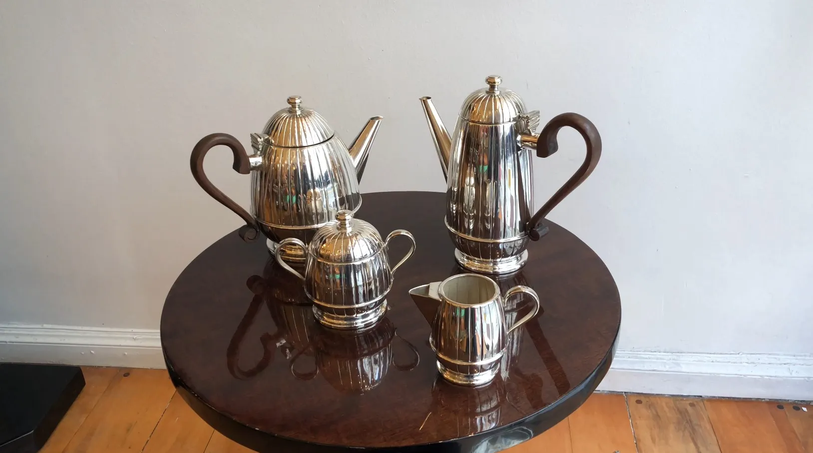 Antique WMF tea set with teapot, creamer, and sugar bowl on table