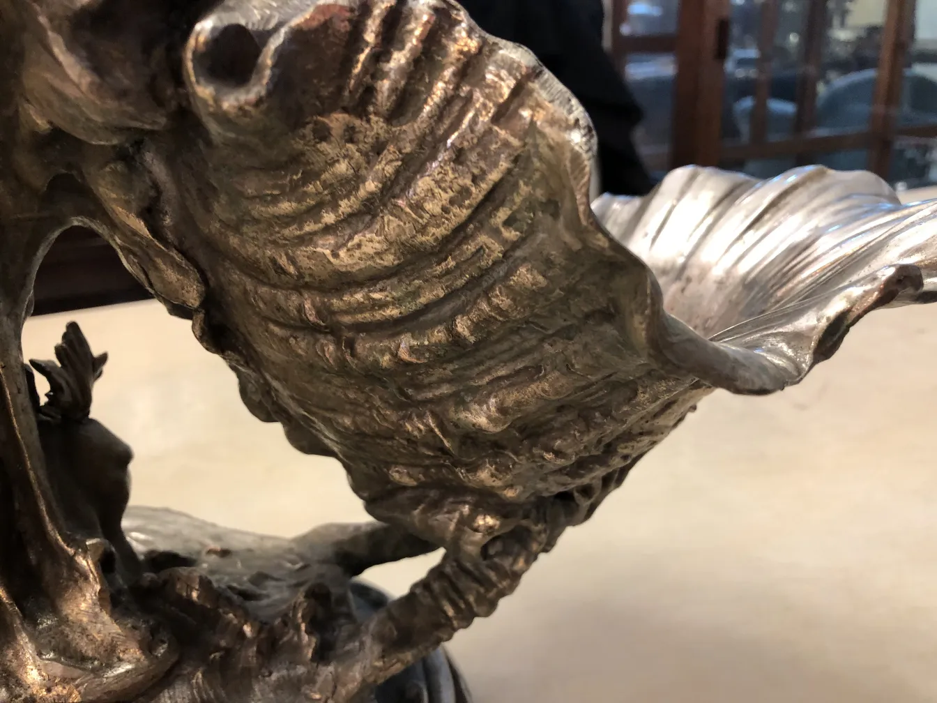 antique centerpiece with intricate ornamental base in a classic setting.